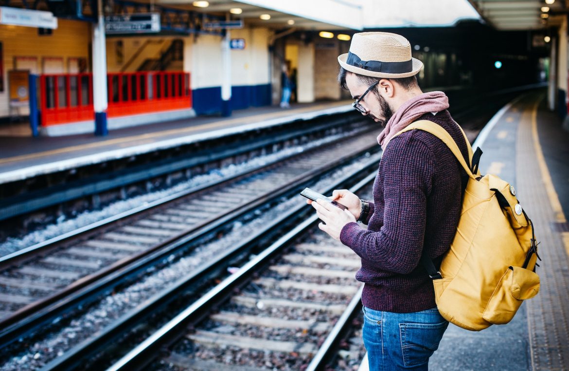 clem-onojeghuo-hmw698cRnHE-unsplash Man on tracks looking at his mobile phone. Image for Predatory loan apps